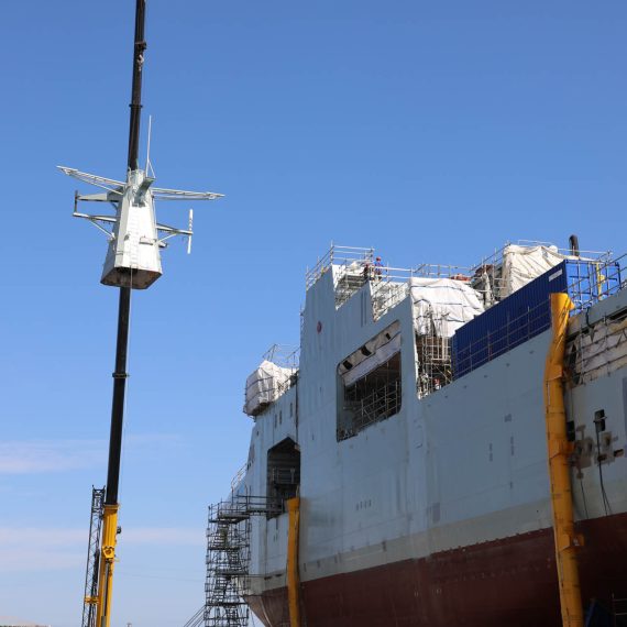 Installing the Forward Mast onto the future HMCS Margaret Brooke, the second Arctic and Offshore Patrol Ship under construction at Halifax Shipyard.
